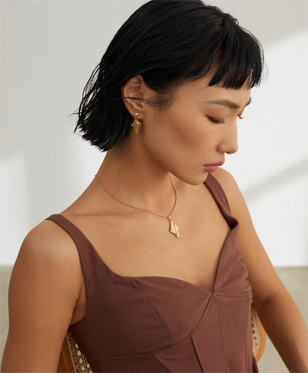 Elegant gold vermeil star charm necklace styled on model