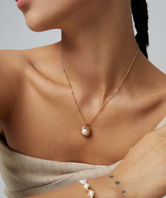 Model wearing Fernovia Design vintage large pearl pendant with gold chain