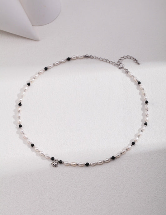 silver necklace featuring spaced black onyx and pearl