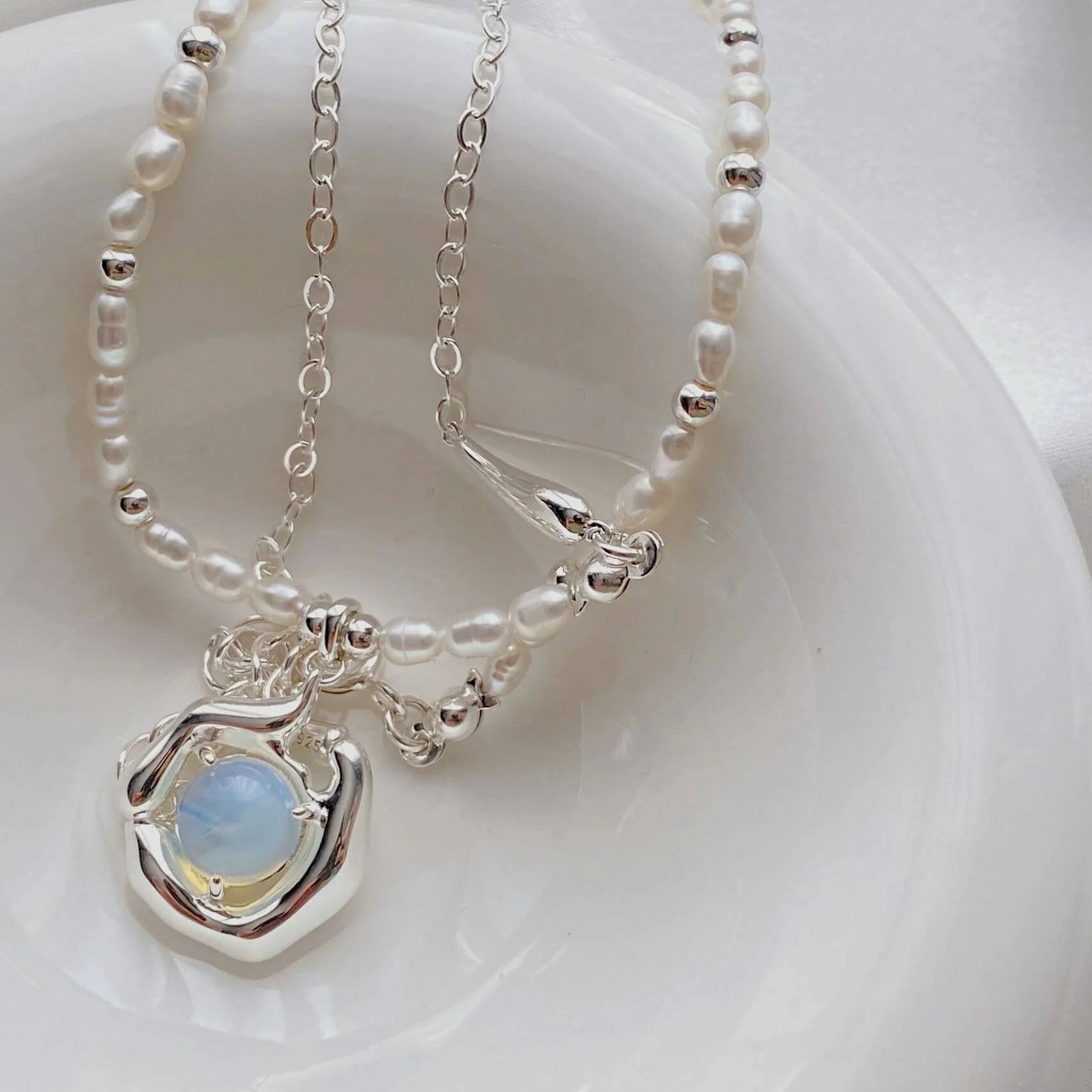 Close-up of freshwater pearls and moonstone on sterling silver necklace, Fernovia Design