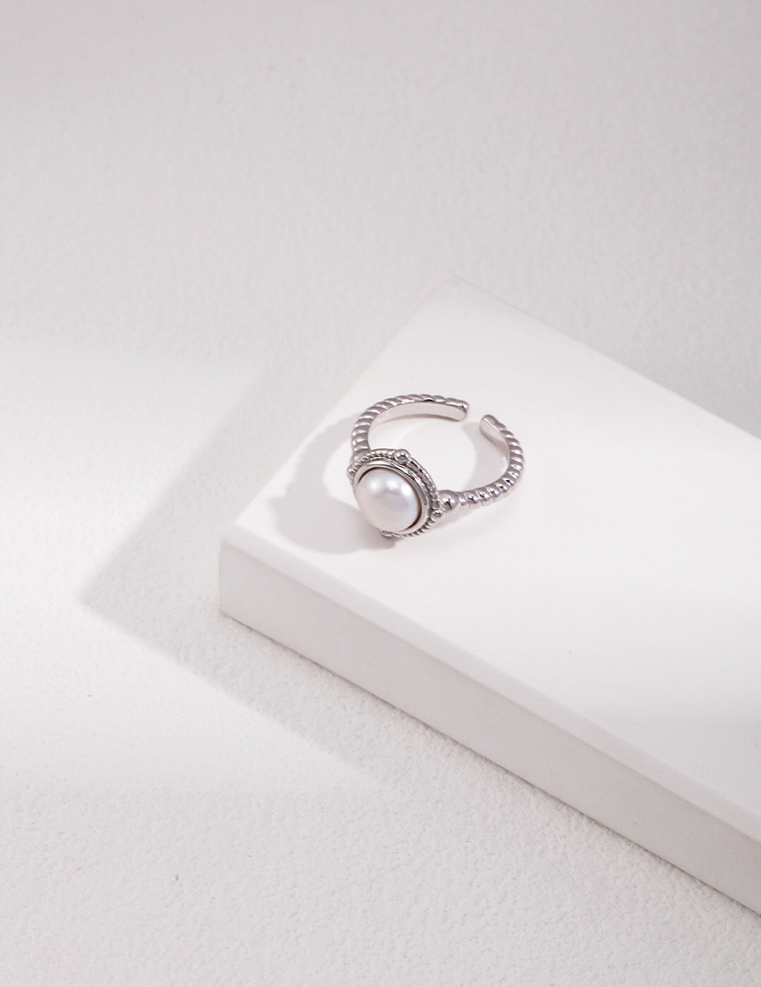 Handcrafted twisted band ring with natural pearl, sterling silver version