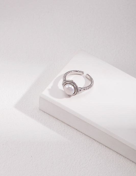 Handcrafted twisted band ring with natural pearl, sterling silver version