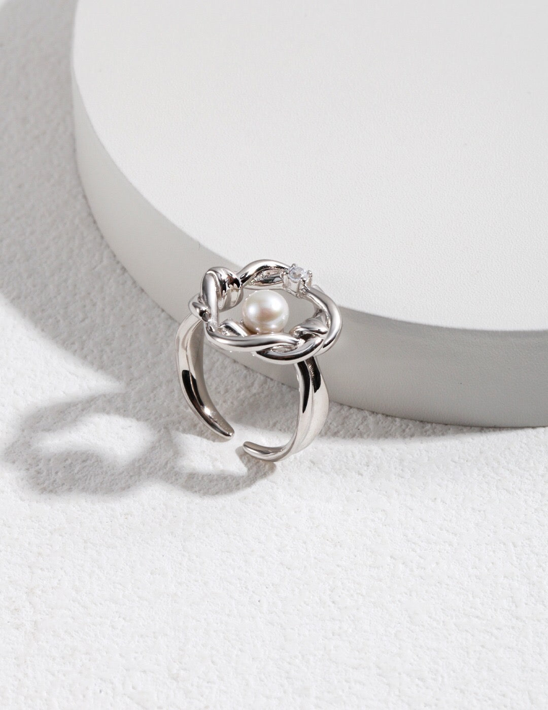 Product display: Fernovia Design twisted floral pearl ring in sterling silver, elegant craftsmanship