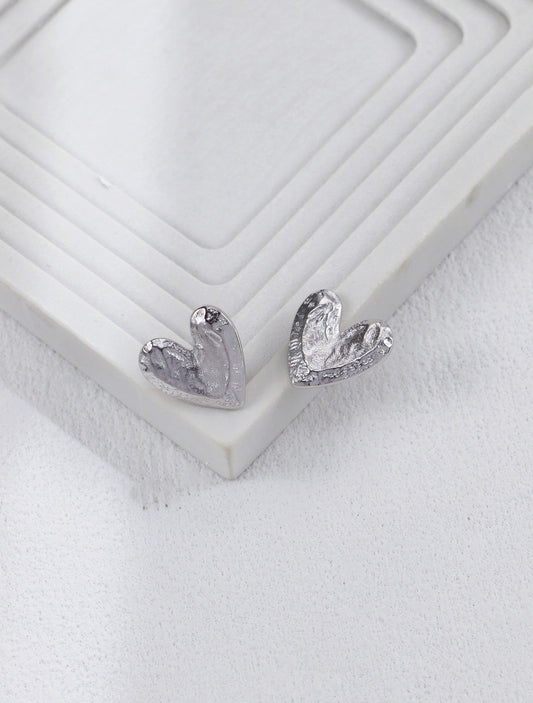 Handcrafted textured heart stud earrings side view
