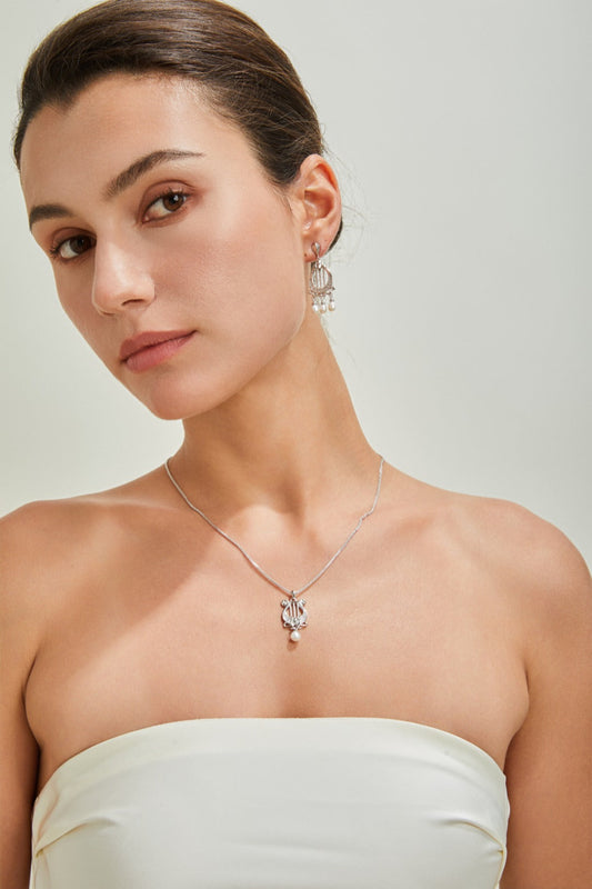 Sterling silver Harp Style Pearl Earrings lifestyle shot – Fernovia Design