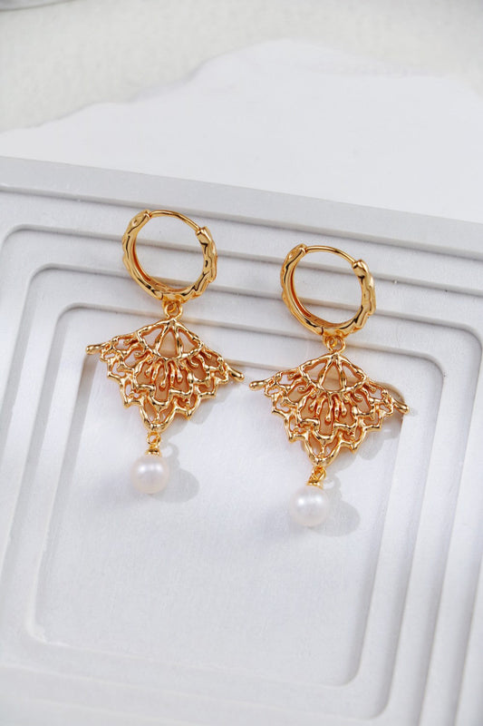 Close‑up of natural freshwater pearl set in gold vermeil romantic skirt drop earrings
